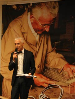 Massimo Pigini with background picture of father Gino Pigini